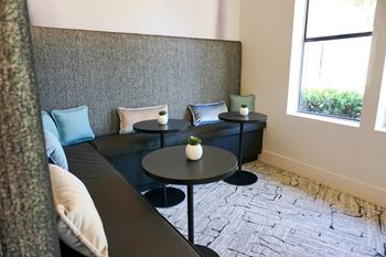Sorelle Apartments Business Center with seating, tables, and accent pillows